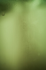 green steam condensation on a glass - freshness abstract background