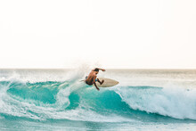 Professional Surfer Riding Waves In Bali, Indonesia. Men Catching Waves In Ocean, Isolated. Surfing Action Water Board Sport. People Water Sport Lessons And Beach Swimming Activity On Summer Vacation