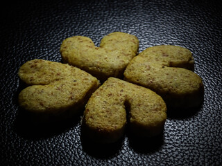 heart-shaped peanut cookies isolated on black background