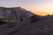A huge boulder on one of the stone slopes next to Olmsted Lookout in Yosemite National Park at sunset