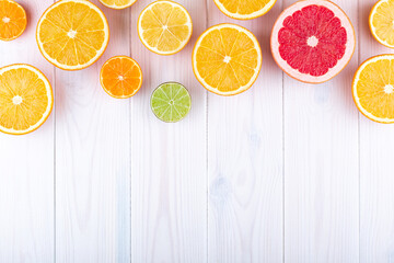 Wall Mural - Citruses on white wooden background