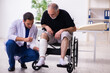 © Elnur - Old injured man visiting young male doctor traumatologist