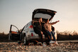 © Romvy - Young Couple Travel with a Car and Enjoys Ride, Weekend and Adventure Concept