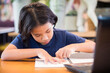 © patpitchaya - Child Girl Doing  Online Homework