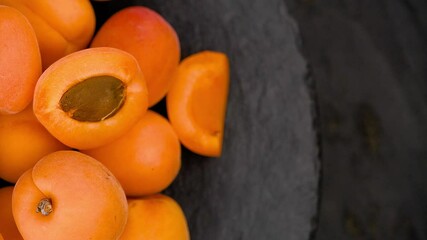 Canvas Print - Portion of Apricots on a rotating plate as seamless loopable 4K footage