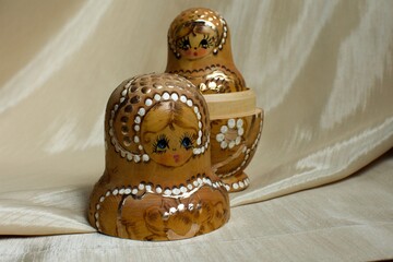 traditional Russian wooden doll painted in gold 