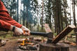 Female strong hands chop firewood with axe for bonfire. Powerful ax blow. Survival on camping trip. Harvesting wood in forest. Camp wild tourists. Splitting logs with sharp hatchet. Young woodcutter