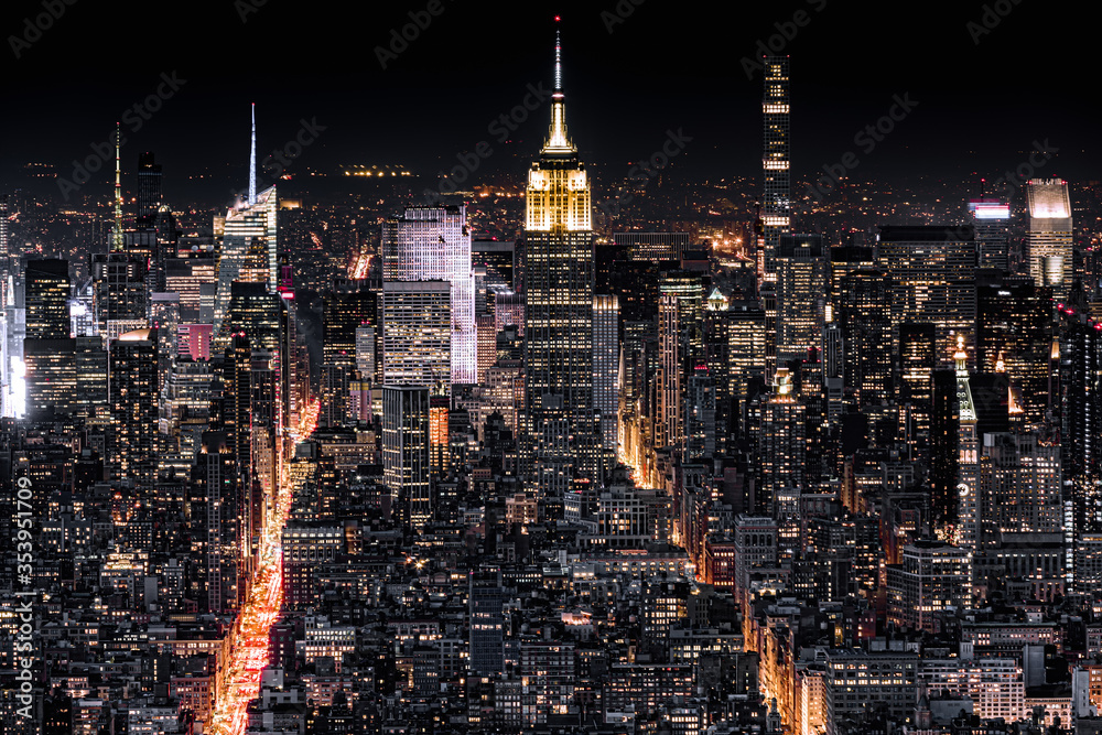 Aerial view of New York City at night with illuminated avenues ...