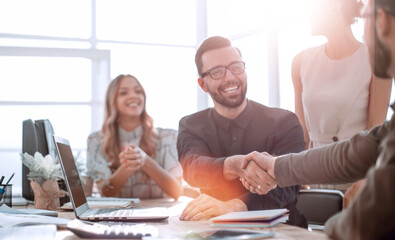 Poster - background image of the handshake of business partners in the office