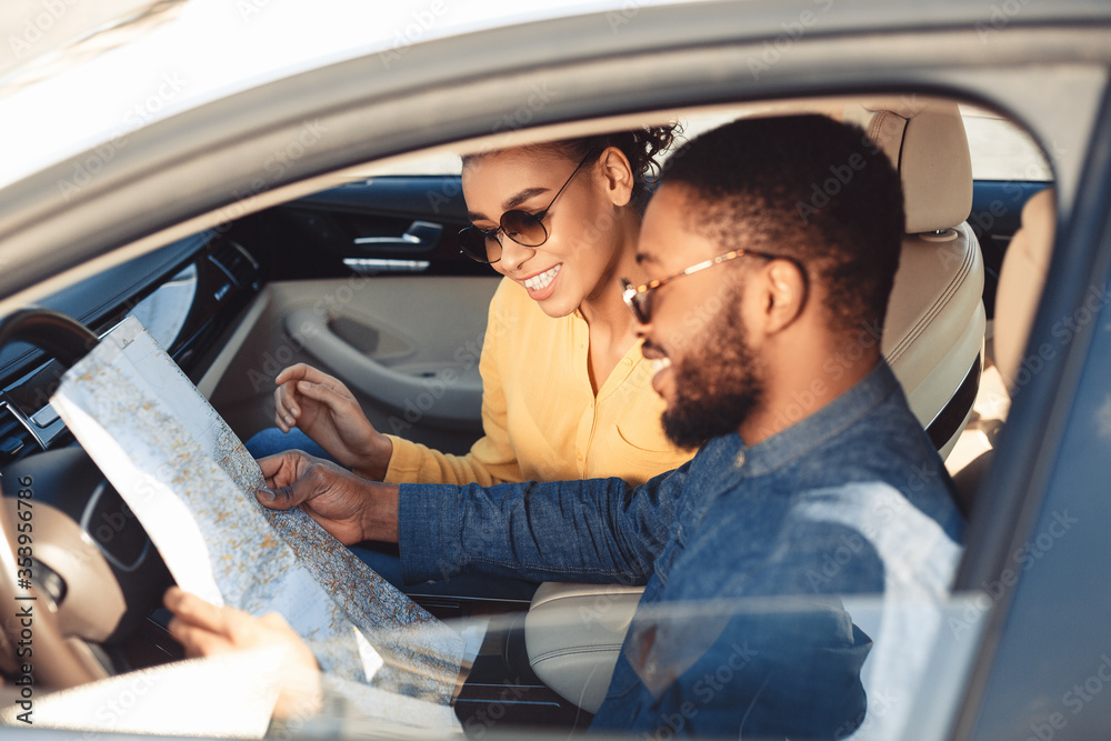 Spouses Looking At Map Sitting In Car Traveling On Vacation - obrazy, fototapety, plakaty 