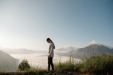 beautiful woman wlking on the top of mount batur, bali, indonesia. mountain hiking at sunrise. batur