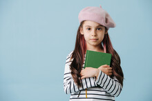 Portrait Of A Fashionable Little Girl In French Beret Hugging A Book