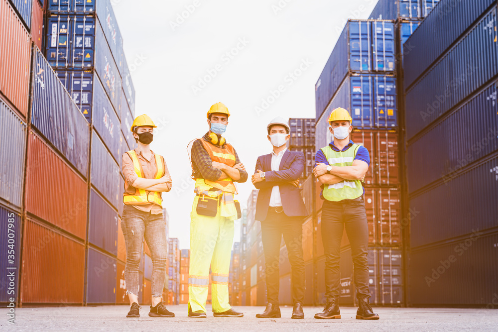 Portrait group of smart creative workers wear protective face masks, safety helmet and uniform for safety in machine industrial factory. Logistic import export and transport industry background. - obrazy, fototapety, plakaty 
