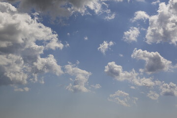 Wall Mural - white fluffy clouds in the blue sky.
