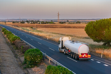 Wall Mural - Tank truck with heat-insulated semi-trailer for the transport of liquids at high temperatures circulating on the highway.