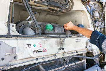 Truck driver in tasks to check vehicle levels