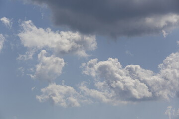 Wall Mural - white fluffy clouds in the blue sky.