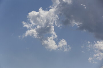 Wall Mural - white fluffy clouds in the blue sky.