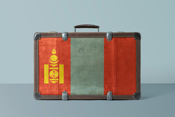 Wall Mural - Mongolia flag on old vintage leather suitcase with national concept. Retro brown luggage with copy space text.