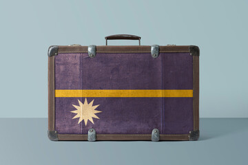 Wall Mural - Nauru flag on old vintage leather suitcase with national concept. Retro brown luggage with copy space text.