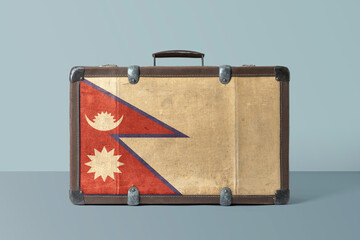 Wall Mural - Nepal flag on old vintage leather suitcase with national concept. Retro brown luggage with copy space text.