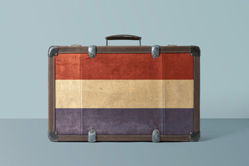 Wall Mural - Netherlands flag on old vintage leather suitcase with national concept. Retro brown luggage with copy space text.