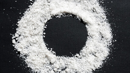 a circle of sea salt on a black background with space for an inscription