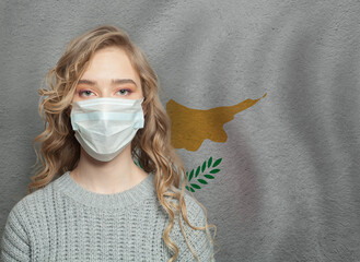 Wall Mural - Young woman wearing a face mask with Cyprus  flag. Flu epidemic and virus protection concept