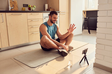 Poster - Cheerful gym instructor communicating with clients online from home