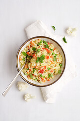 Wall Mural - Cauliflower rice in bowl on a white background. Paleo Food Diet Concept