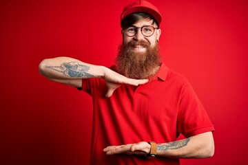 Poster - Young handsome delivery man wearing glasses and red cap over isolated background gesturing with hands showing big and large size sign, measure symbol. Smiling looking at the camera. Measuring concept.