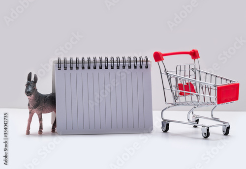 Cuadros en Lienzo shopping list with donkey and supermarket trolley on a white background
