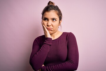 Sticker - Beautiful young woman wearing casual bun hairstyle over pink isolated background thinking looking tired and bored with depression problems with crossed arms.