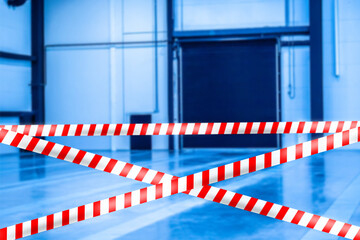 Poster - Fence tape on the background of an empty warehouse. Concept - warehouse operation was terminated due to quarantine. Company is closed. Concept - ban on entry because of the risk of infection.