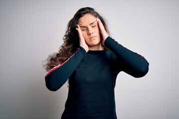 Sticker - Young beautiful woman with curly hair wearing casual sweater over isolated white background with hand on head for pain in head because stress. Suffering migraine.