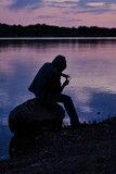 Fototapeta Do akwarium - silhouette of a fisherman on the lake