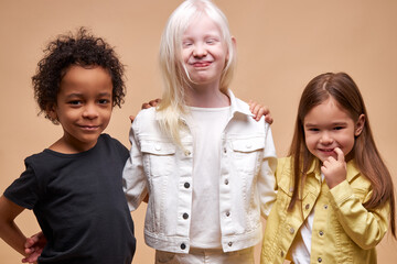 portrait of cheerful positive kids, multiethnic children isolated in studio. adorable dark skinned a