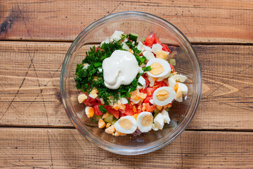 Step-by-step preparation of salad with salted salmon, fresh cucumbers and herbs, step 6 - adding sour cream with mustard, top view, selective focus