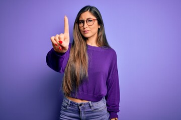 Wall Mural - Young beautiful smart woman wearing glasses over purple isolated background Pointing with finger up and angry expression, showing no gesture