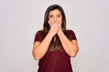 Sticker - Young hispanic woman wearing casual t-shirt standing over isolated background shocked covering mouth with hands for mistake. Secret concept.