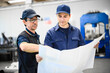 © Minerva Studio - Two engineers looking at a blueprint in a facility