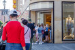 Selected focus view, Group of European women queue and wait for shopping on sidewalk outside store during social distancing and quarantine regulations for COVID-19 virus in Düsseldorf, Germany.