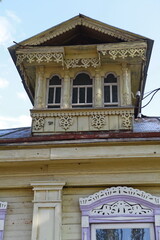 Vintage rural wooden house with ornamental carved windows, frames in Suzdal town, Vladimir region, Russia. Russian traditional national folk style in architecture. Village, countryside