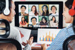 Rear view of Asian partner working and online meeting via video conference with colleague and team building