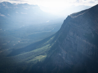 Wall Mural - Beautiful alpine valley scene with hazy light,shot at Mount St. Piran summit, Banff National Park, Alberta, Canada