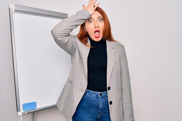 Sticker - Young beautiful redhead businesswoman doing business presentation using magnetic board surprised with hand on head for mistake, remember error. Forgot, bad memory concept.