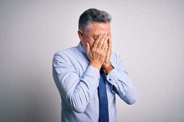 Sticker - Middle age handsome grey-haired business man wearing elegant shirt and tie with sad expression covering face with hands while crying. Depression concept.