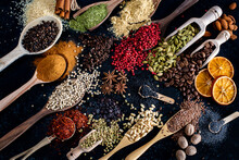 Many Spices And Herbs On The Dark Background Table