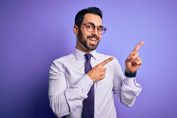 Sticker - Handsome businessman with beard wearing casual tie and glasses over purple background smiling and looking at the camera pointing with two hands and fingers to the side.