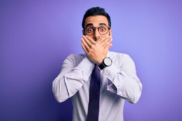 Sticker - Handsome businessman with beard wearing casual tie and glasses over purple background shocked covering mouth with hands for mistake. Secret concept.